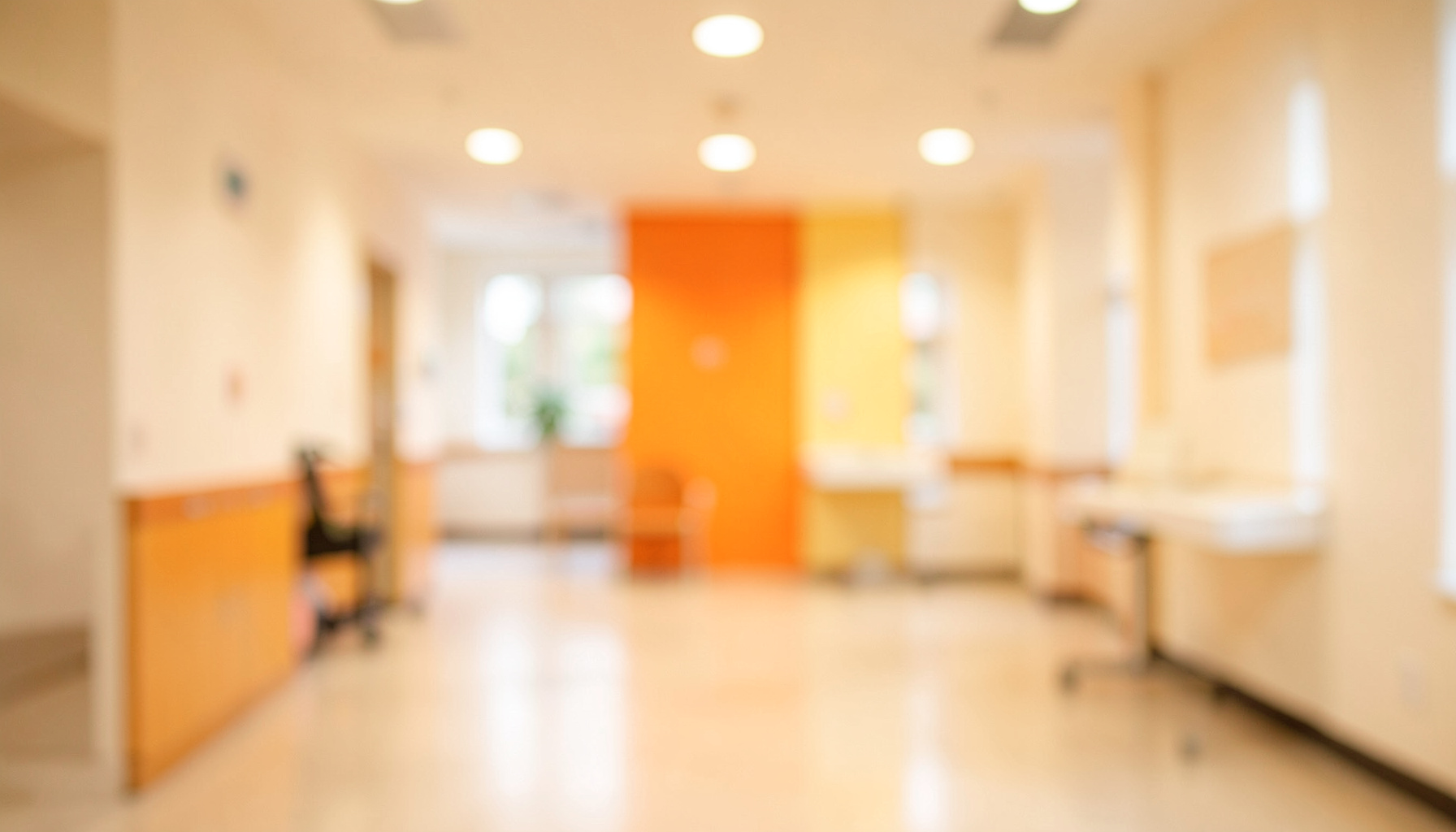 Warm, softly lit healthcare environment with gentle bokeh background, conveying compassion and dedication